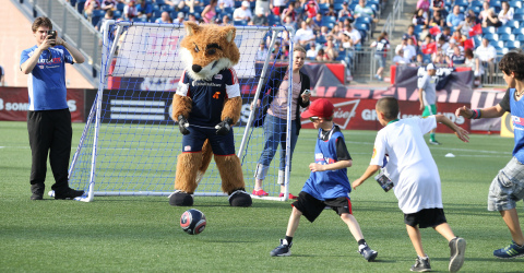 New England Revolution mascot Slyde plays goalie in a fans' 4-vs.-4 soccer match during halftime of  ... 