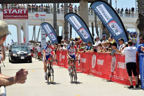 Attendees and fans cheer as racers from team Flying Frenchies of France start the 3,000 mile Race Ac ... 