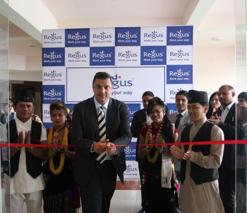 Mr. Madhusudan Thakur, Regional Vice-President, South Asia, Regus, flanked by youths wearing traditi ... 