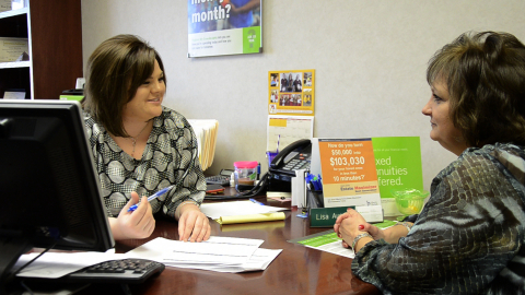 Lisa Austin, left, Regions Bank branch manager in Hot Springs, Ark., speaks with colleague Kathy Jac ... 