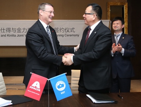 Axalta's Industrial Coatings President Michael Cash and Kinlita Chairman Wu Guozheng shake hands aft ... 