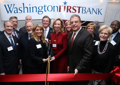 The Honorable Barbara Comstock (center with scissors) cutting ribbon with CEO Shaza Andersen (left w ... 