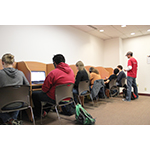 Michael Perry, a GG Interactive employee, walks students through a lesson on computer science and game programming. (Photo: Business Wire)
