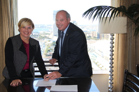 Joel Singer, CEO of zipLogix, and Beth Young, vice president, realty segment for Stewart, sign strat ... 