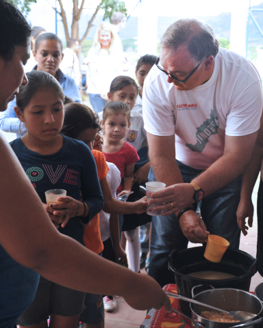 Greg Creed, Chief Executive Officer of Yum! Brands, served food to children in a community in Jinote ... 
