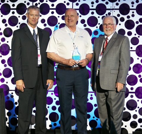 Dr. Richard Borst receives his award from W.A. Rodda and Randy J. Ripperger from IAAO in Tampa, Flor ... 