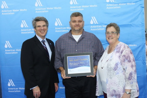 Illinois American Water Cairo District Operations Superintendent Mike Brown (center) accepts the AWW ... 