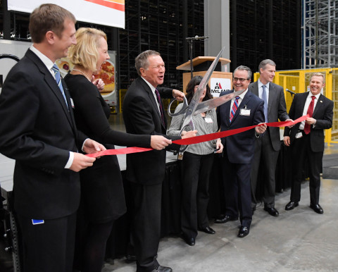 Gov. John Kasich cuts the ribbon during a ceremony celebrating McLane’s newest facility in Findlay,  ... 