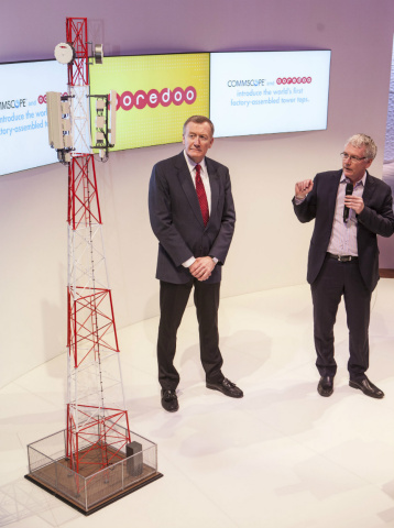 Paul Salmon, group chief technology officer, Ooredoo (right) and Randy Crenshaw, chief operating officer, CommScope (left), discuss the new factory-assembled network tower tops using a tower demonstration model. (Photo: Business Wire)