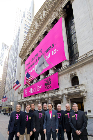 The executive management team of T-Mobile US, Inc., led by President and CEO John Legere (center, front) and CFO J. Braxton Carter (center, rear), gathers outside the New York Stock Exchange on May 1, 2013 in New York City before ringing the Opening Bell to commemorate the company's listing. (Photo by Ben Hider/NYSE Euronext)