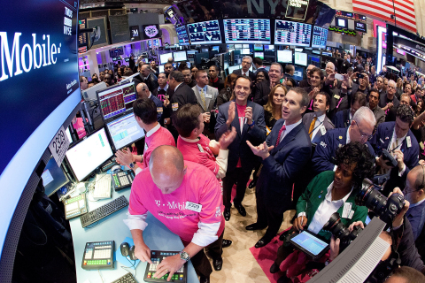 John Legere, President and CEO of T-Mobile US, Inc., (center) gathers with traders on the floor of the New York Stock Exchange as T-Mobile US, Inc. begins trading following the successful completion of its combination with MetroPCS on May 1, 2013. (Photo by Ben Hider/NYSE Euronext)