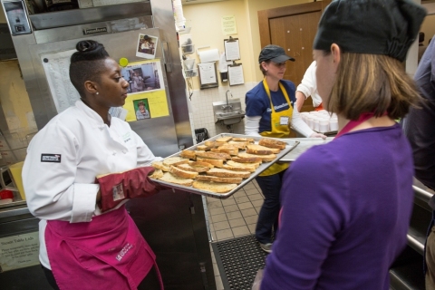 Cardinal Trust & Investments Portfolio Analyst Stacey Shaw prepares breakfast at Miriam's Kitchen. (Photo: David Galen, Galen Photography)