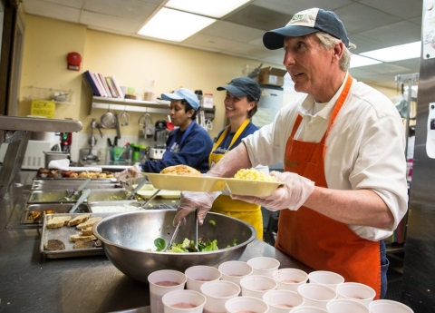 Cardinal Bank President Kevin Reynolds serves breakfast to Miriam's Kitchen's guests. (Photo: David Galen, Galen Photography)