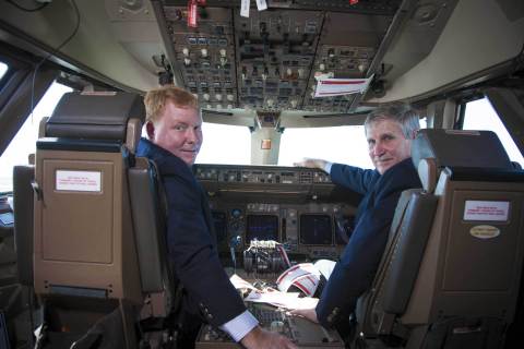 William "Billy" Moore, president MidairUSA, and Richard A. Ennis, executive director Melbourne International Airport, sit in the cockpit of a Transaero Airlines Boeing 747-400 currently undergoing
modifications at the airport (Photo: Business Wire)