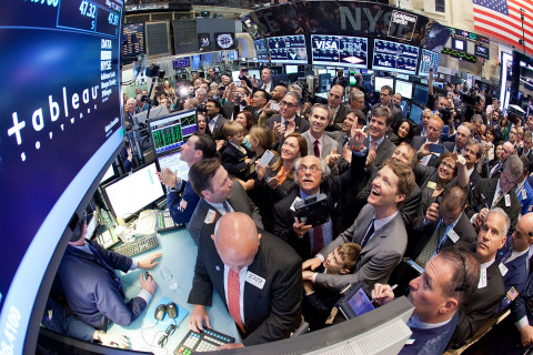 Tableau Software CEO and Co-founder Christian Chabot (lower right with young child) in the NYSE trading crowd as the company's stock opens on the NYSE. (Photo: Business Wire) 