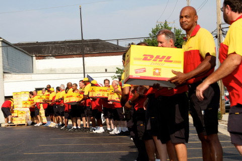 DHL employees load pizzas into trucks at the Guinness Book of World Records' largest pizza delivery in history. (Photo: Business Wire)