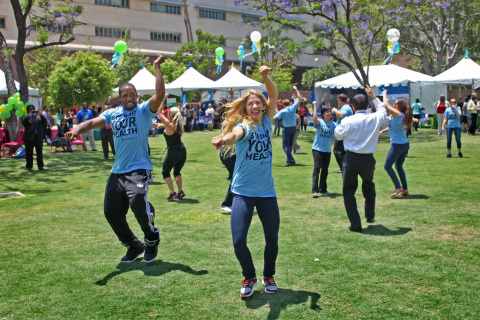 Actors and professional dancers Stephen "tWitch" Boss (left) Allison Holker (right) of "So You Think You Can Dance" lead Los Angeles County employees in a group dance activity Tuesday, May 21, at Grand Park in downtown Los Angeles. Holker and Boss helped announce UnitedHealthcare's expansion of the Diabetes Prevention & Control Alliance programs to Los Angeles County employees. The announcement was made at the Fourth Annual Countywide Fitness Challenge at Grand Park in downtown Los Angeles where early 1,000 county employees attended (Photo: Jamie Rector).