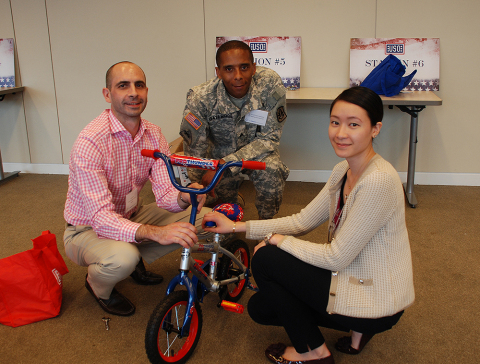 Moody's employees participate in a USO Bike Build event for military families at the company's headquarters in New York. (Photo: Business Wire)