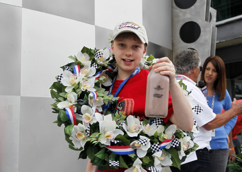 Christopher Bienusa, a 12-year-old from Alexandria, Minn., celebrates winning the Hot Wheels "World's Best Driver Championship" in traditional Indy 500 fashion on Saturday, May 25 at the Indianapolis Motor Speedway. Coached by racing legends Mario and John Andretti, Smith's toy-size car finished first on the world record-setting one mile-long iconic Hot Wheels orange toy track. (Photo: Business Wire)