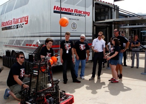 FIRST(R) Robotics Competition (FRC(R)) Team "Robowranglers" from Greenville, Texas demo their basketball-shooting robot for IZOD IndyCar series racer Charlie Kimball at the Firestone 550 at Texas Motor Speedway on June 8, 2013. (Photo: Business Wire)