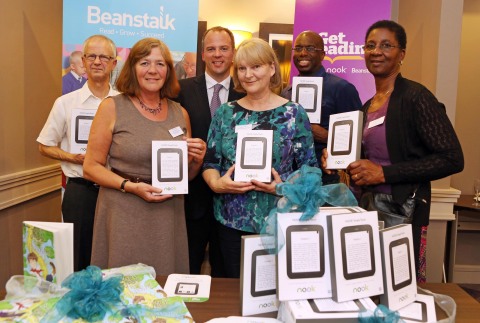 Jim Hilt, Managing Director, Barnes & Noble (centre), gifts NOOK(R) Simple Touch eReaders to Beanstalk volunteers, Paul Manning, Lesley Shepherd, Susan Cooke, Ron Charles and Sylvia Murray at the charity's 40th anniversary celebration. As part of the Company's support of the Get Reading campaign, Barnes & Noble presented the Beanstalk Literacy Charity with a donation of 1,000 NOOK eReaders, all loaded with free content, to be used by Beanstalk volunteers to promote literacy in schools across the UK. (Photo: Business Wire)