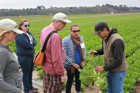 Stanley Rutledge and Vanessa Coffman of STOP Foodborne Illness take a closer look at a head of romaine held by Bryson Ikeda of Ikeda Farms, Oceano CA as Emily Grabowski, who was sickened in a past leafy greens outbreak, and April Ward of the California Leafy Greens Marketing Agreement look on. (Photo: Business Wire)