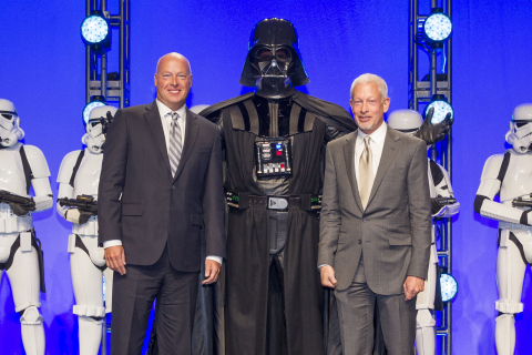 Disney Consumer Products President, Bob Chapek, left, and Lucasfilm Executive Vice President Howard Roffman pose with Darth Vader and 20 Stormtroopers as they take over the stage during a private Disney event at the Licensing Expo, Monday June 17, 2013 at the Mandalay Bay Convention Center in Las Vegas. This surprise grand finale, presented to more than 1,500 licensees, demonstrates a new era of merchandising potential for Disney Consumer Products' robust franchise portfolio, which now includes the Star Wars franchise. (Photo by Eric Jamison/Invision for Disney Consumer Products/AP Images)