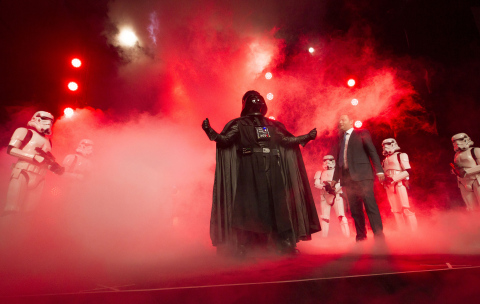 Disney Consumer Products Executive Vice President Josh Silverman is interrupted by "The Imperial March" led by Darth Vader and 20 Stormtroopers as they take over the stage during a private Disney event at the Licensing Expo, Monday June 17, 2013 at the Mandalay Bay Convention Center in Las Vegas. This surprise grand finale, presented to more than 1,500 licensees, demonstrates a new era of merchandising potential for Disney Consumer Products' robust franchise portfolio, which now includes the Star Wars franchise. (Photo by Eric Jamison/Invision for Disney Consumer Products/AP Images)