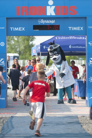 UnitedHealthcare mascot Dr. Health E. Hound is at the finish line as young athletes complete the UnitedHealthcare IRONKIDS Syracuse Fun Run Race. Photo Credit: Rick Mossotti