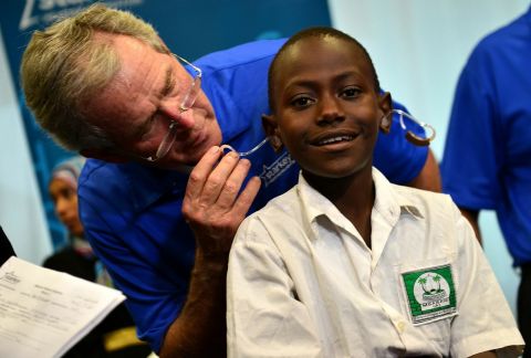 Former President George W. Bush fits a patient with hearing aids at a Starkey Hearing Foundation mission in Dar es Salaam. (Photo: Starkey Hearing Foundation)