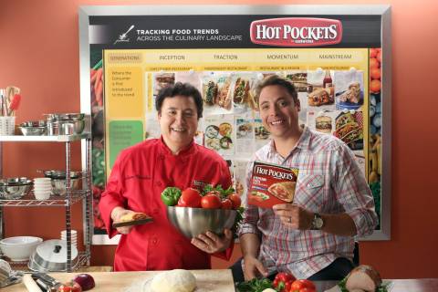 In this photo released by Nestlé Prepared Foods/Hot Pockets brand sandwiches on July 16, 2013 - Food Network's "Sandwich King" Jeff Mauro and Chef Lucien Vendôme, Director of Nestlé Culinary Innovations, reveal the new Hot Pockets brand sandwiches at the Nestlé kitchen in Chatsworth, Calif. (Photo by Casey Rodgers/Invision for Nestlé Prepared Foods/Hot Pockets/AP Images)