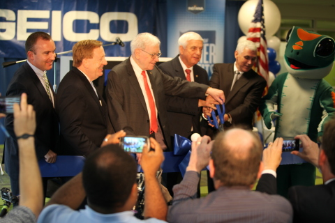 It was all smiles earlier today when GEICO marked the official opening of its new Greater Indianapolis office. Taking part in the ribbon-cutting event along with GEICO's 250 new associates were (from left) GEICO sales and service director Gary McKenzie, Carmel Mayor James Brainard, Berkshire Hathaway Chairman and CEO Warren Buffett, GEICO Chairman and CEO Tony Nicely, Indiana Governor Mike Pence and the GEICO Gecko. Photo by GEICO