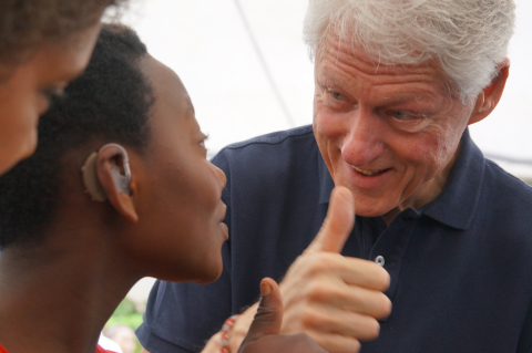 President Bill Clinton fits a patient with hearing aids at a Starkey Hearing Foundation mission in Rwanda in August 2013 (Photo: Starkey Hearing Foundation)