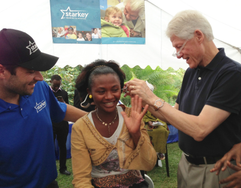 President Bill Clinton and Steven Sawalich, senior executive director of the Starkey Hearing Foundation, fit a patient with hearing aids at a mission in Rwanda in August 2013 (Photo: Starkey Hearing Foundation)