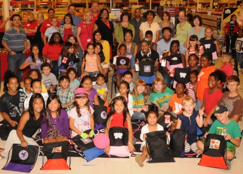 San Diego, Calif. - Nick Cannon surrounded by some of the recipients of 3,500 Office Depot Foundation sackpacks during a Back-to-School Celebration event at an Office Depot store in San Diego. The nonprofit organizations and schools receiving the donations included: Bayside Community Center, Pazzaz Inc., Promises2Kids, Rolling Readers, San Diego Unified School District and YMCA of San Diego County (Photo Credit: Launey LeSage).