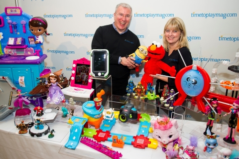 Chris Byrne (L), content director of TimetoPlayMag.com, aka The Toy Guy (R) and Laurie Leahey (R), senior editor, appear with the toys named to the 2013 Most Wanted list, a roundup of 20 items predicted to be the most in-demand this holiday season, during the TimetoPlayMag.com Holiday Showcase press event in New York, September 26, 2013. TimetoPlayMag.com, the number one source for all things play, provides independent product reviews and real-time price comparison for thousands of children's products. (Photo: Business Wire)