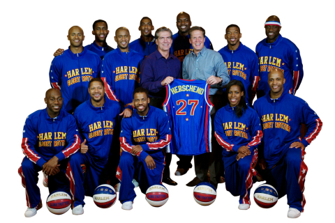 Herschend Family Entertainment President & CEO Joel Manby (left, holding jersey) and Harlem Globetrotters CEO Kurt Schneider (right, holding jersey) have announced HFE's acquisition of the legendary team, which becomes the 27th property owned by the largest family-owned themed attractions corporation in the U.S. Harlem Globetrotters pictured are -- Back row, l-r: Bull Bullard, Hi-Lite Bruton, Big Easy Lofton; Middle row, l-r: Dizzy Grant, Scooter Christensen, Buckets Blakes, Special K Daley; Front row, l-r: Firefly Fisher, Handles Franklin, Ant Atkinson, TNT Maddox, Flight Time Lang. (Photo: Business Wire)