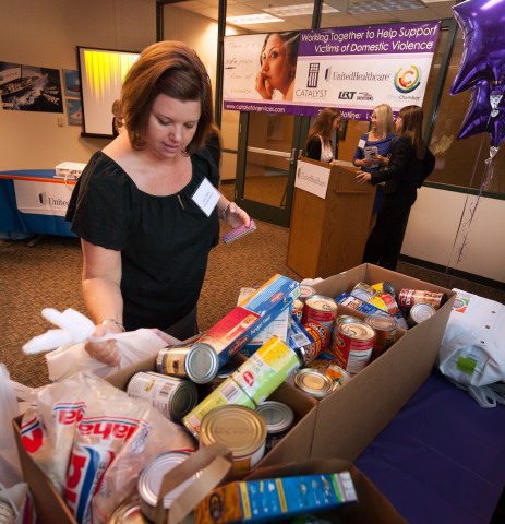 Arica Stiliha, UnitedHealthcare recruiter, places a food donation for Catalyst Domestic Violence Services at the Chico Chamber of Commerce breakfast forum held at UnitedHealthcare Chico Operations Center (Photo: Brian Peterson).