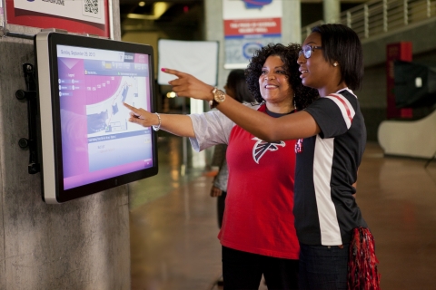 Atlanta Falcons fans use interactive technology from Duluth, Ga.-based NCR that helps them navigate their way around the Georgia Dome simply with a tap of a finger. (Photo: Business Wire)