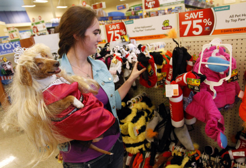 Rainbow, a miniature dachshund, and her pet parent Teresa Tubbs shop for another costume during the company's annual Halloween costume party. (Richard W. Rodriguez/AP Images for PetSmart)