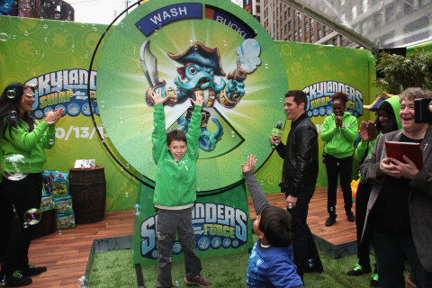 NEW YORK, NY - OCTOBER 10: In this photo distributed by Activision Publishing Inc., Skylanders&reg; James Marsden awards a Skylanders SWAP Force&trade; starter pack to Ethan W. during the Skylanders SWAP Force&trade; launch event in Times Square in New York City on October 10, 2013. (Photo by Donald Bowers/Getty Images for Activision)