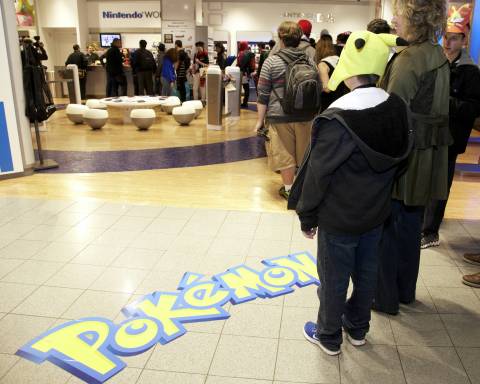 In this photo provided by Nintendo of America, the first wave of Pokemon fans eagerly await their chance to purchase Pokemon X and Pokemon Y at Nintendo World in New York just after midnight on Oct. 12, 2013.