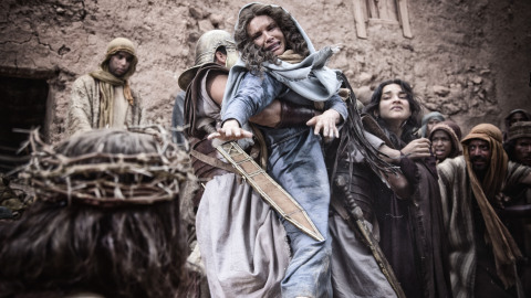 Mary (Roma Downey) struggles with a centurion. (Photo credit: Casey Crafford.)