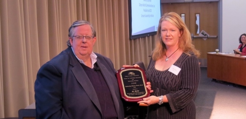 Art Barter receiving Leadership Award from Emilie Hersh, last year’s award recipient. (Photo: Business Wire)
