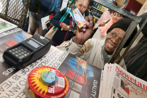 South African woman uses her SASSA MasterCard Debit card to make purchases at local shop. (Photo: Business Wire)

