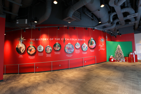 As part of the World of Coca-Cola's holiday celebration, guests can learn about the history of the iconic Coca-Cola Santa. They also can make memories of their own by stepping inside a classic Sundblom Santa painting and taking photos under the Christmas tree. (Photo: Business Wire)