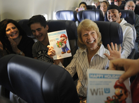 In this photo provided by Nintendo of America, Linda A. from Clearwater, FL, shows her excitement when Nintendo surprises passengers on Southwest Airlines flight 1883 from New Orleans to Dallas Love Field with vouchers for free Wii U systems. Nintendo is partnering with Southwest Airlines to bring Wii U, Nintendo's newest home console, and family-friendly games to holiday travelers in terminals across the country. (Photo: Business Wire)