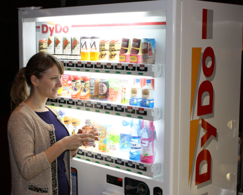 A Muscovite buys a drink from a beverage vending machine set up in Moscow by DyDo DRINCO RUS,LLC. (Photo: Business Wire)