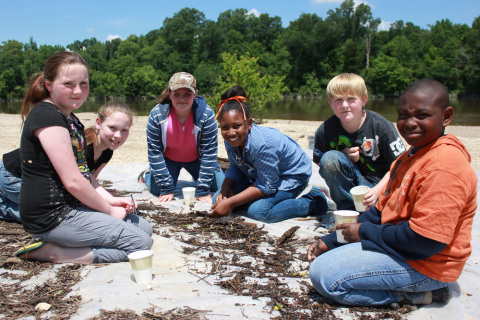 These 5th grade students from New Augusta Elementary pause from collecting and identifying aquatic insects from the Leaf River during a May 2013 Discovery Day field trip, part of Georgia-Pacific's environmental education program at its New Augusta, Miss., site. (Photo: Business Wire)