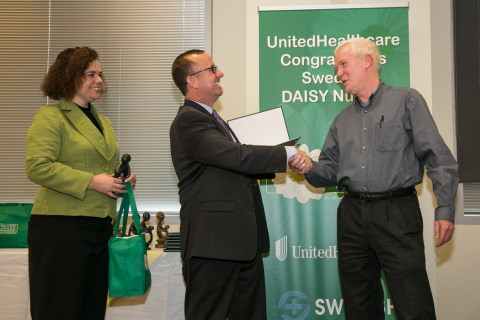 Mike Collins, RN from Swedish Medical Center's First Hill campus, right, receives The DAISY Award from David Hansen, CEO of UnitedHealthcare Northwest Region, and Melissa Barnes, vice president, The DAISY Foundation (Photo: Kim Doyel).